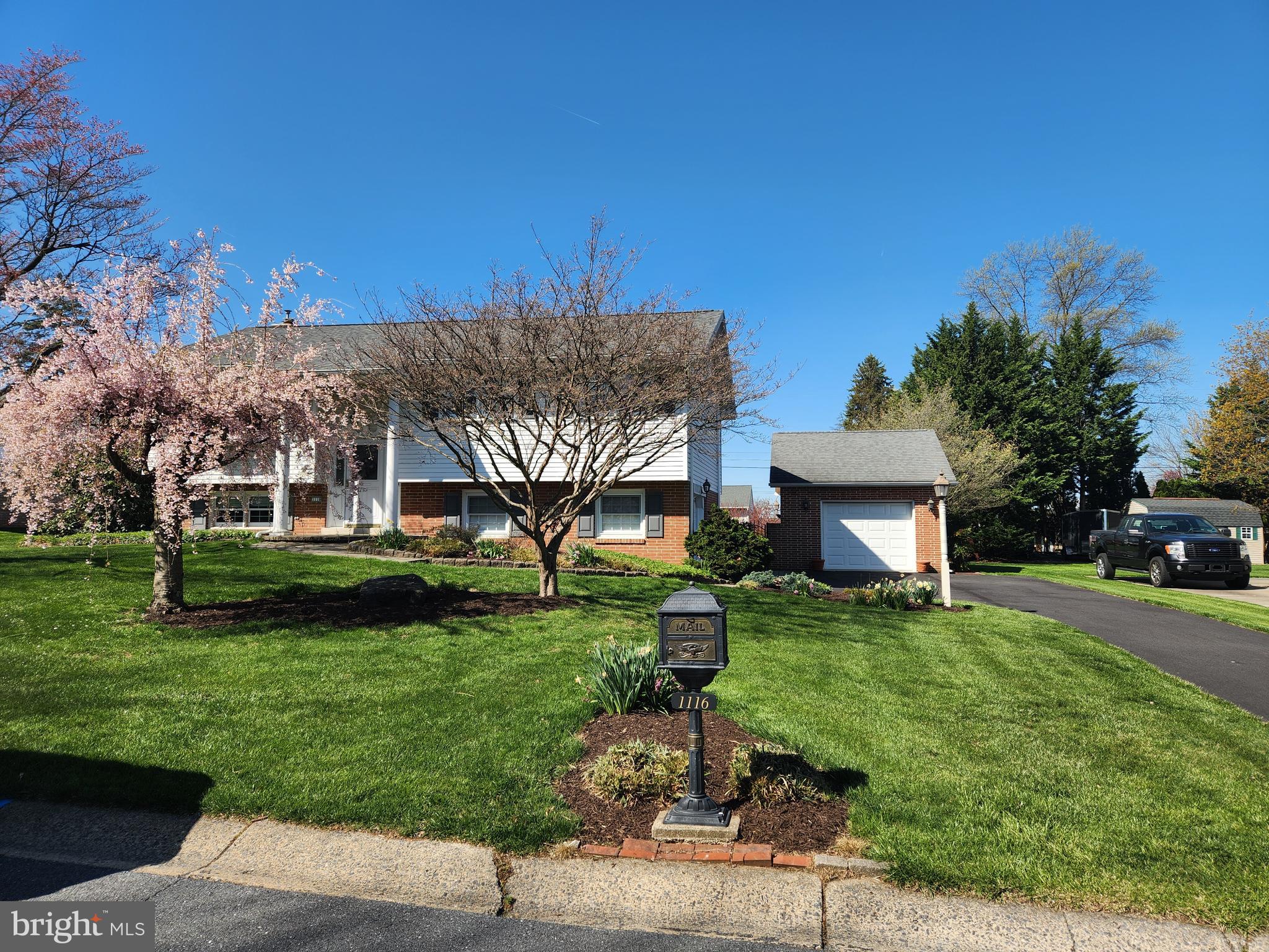 1116 Devonshire Road Lancaster, PA 17601 - Photo 47 of 70 a front view of a house with a garden and trees