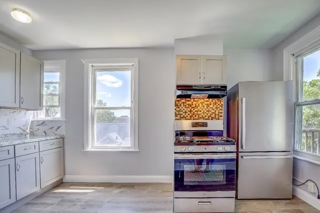 a kitchen with stainless steel appliances granite countertop a stove and a refrigerator