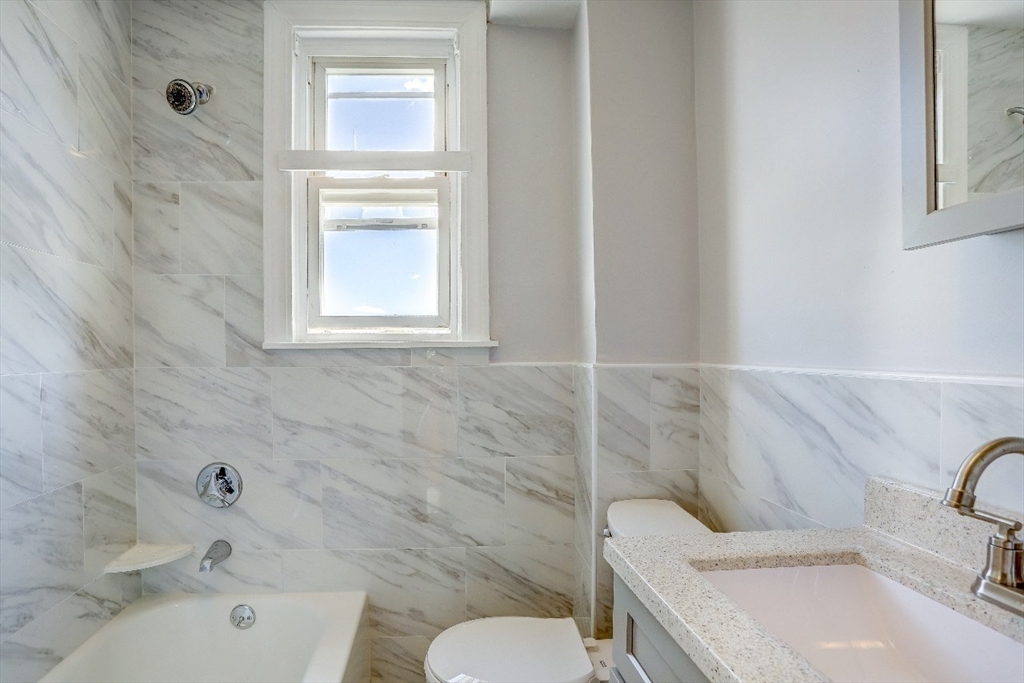 83 Topliff Street, Unit ALL Boston, MA 02122 - Photo 17 of 25 a bathroom with a sink and a toilet