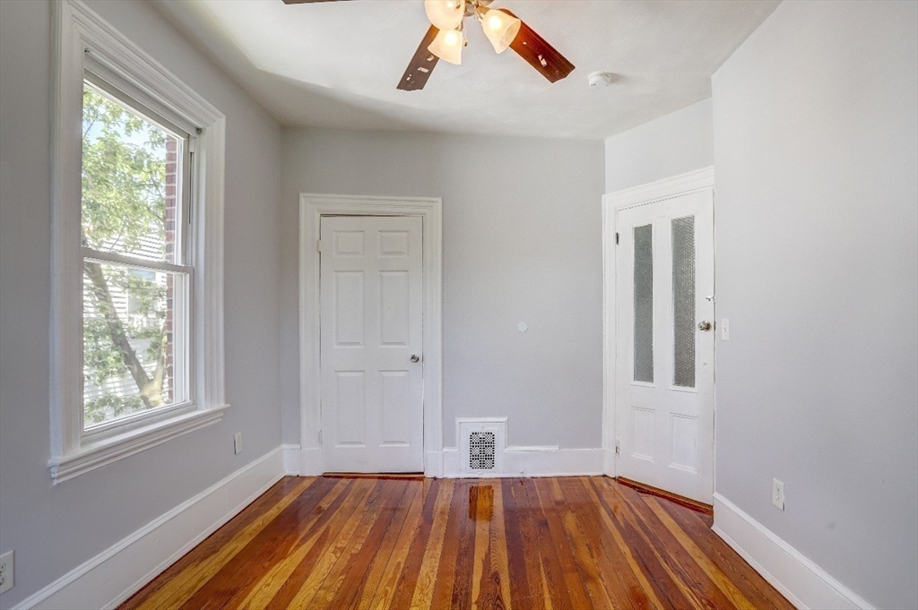 83 Topliff Street, Unit ALL Boston, MA 02122 - Photo 20 of 25 a view of room with window and hardwood floor