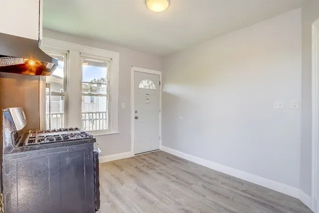 a view of room with window and wooden floor