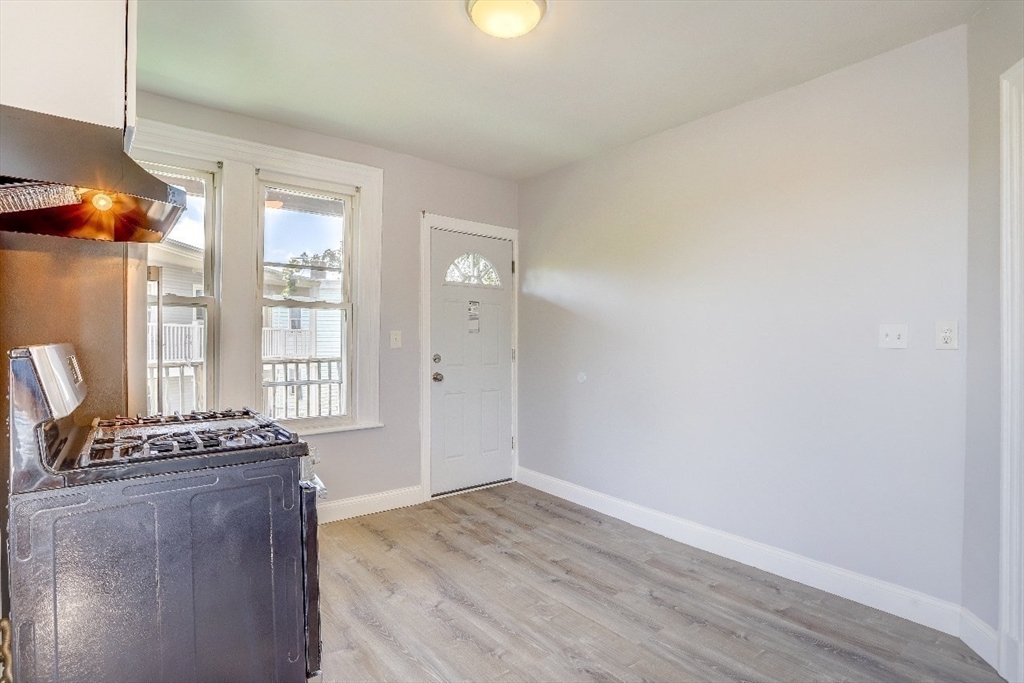 83 Topliff Street, Unit ALL Boston, MA 02122 - Photo 9 of 25 a view of room with window and wooden floor