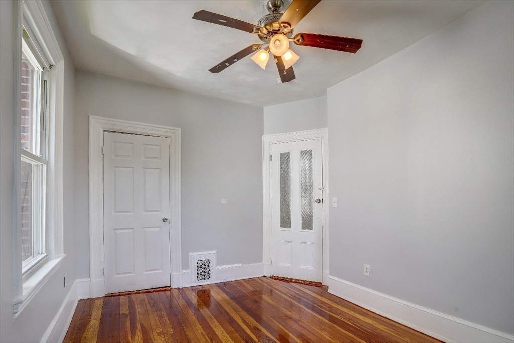 83 Topliff Street, Unit ALL Boston, MA 02122 - Photo 10 of 25 wooden floor in an empty room with a window