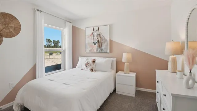 a bedroom with a bed and a lamp