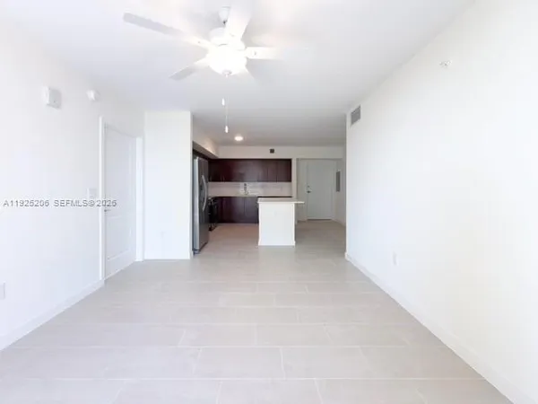 a view of a kitchen with a sink and a refrigerator