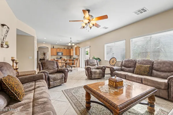 a living room with furniture a ceiling fan and a window