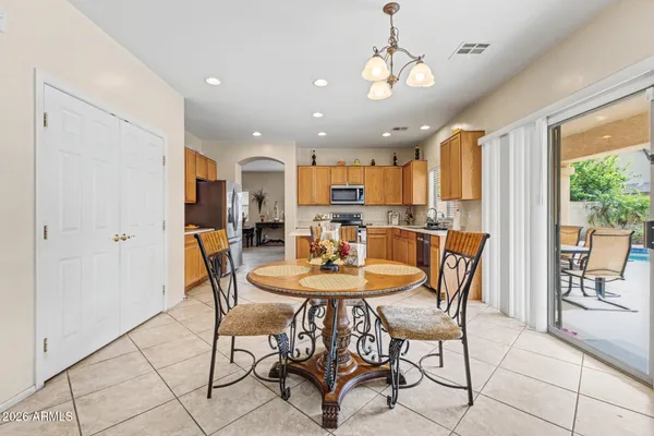 a view of a dining room with furniture and a chandelier
