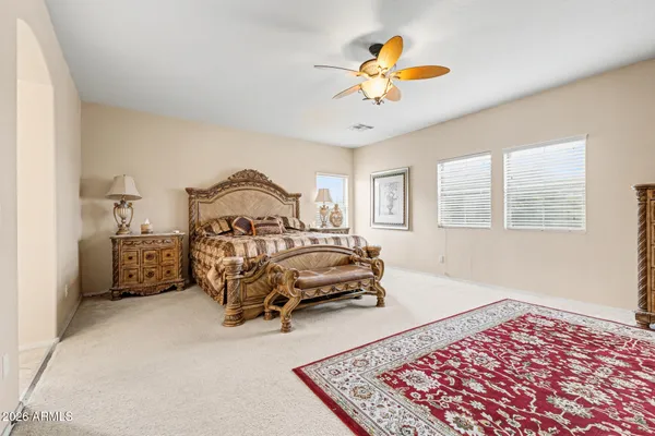 a bedroom with a bed and a chandelier