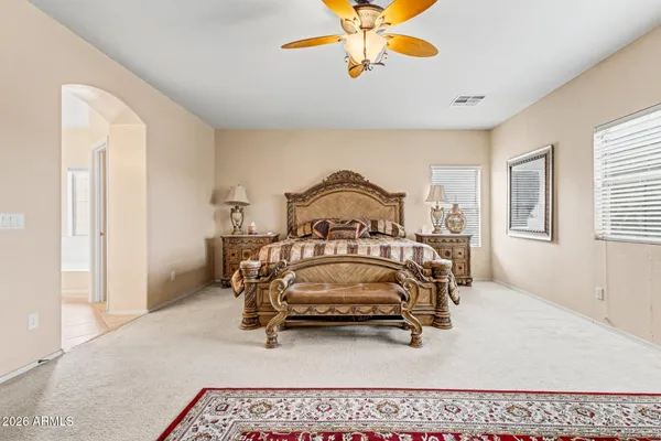 a bedroom with a bed and a chandelier