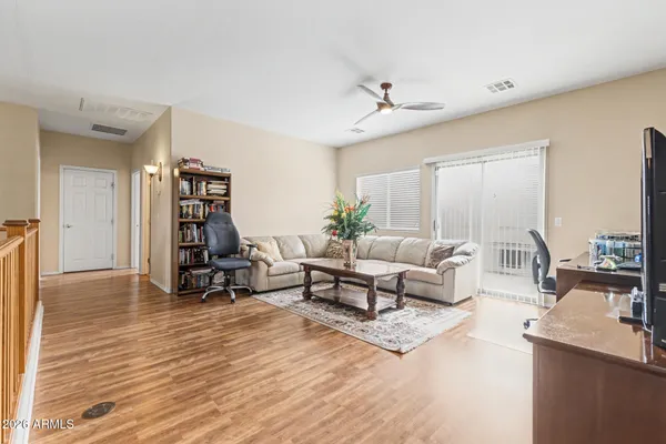 a living room with furniture and a wooden floor