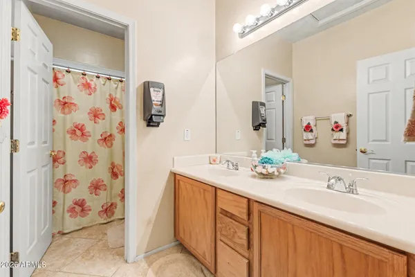 a bathroom with a sink double vanity and a mirror