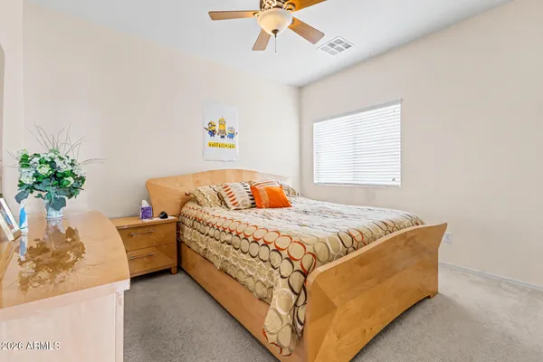 a bedroom with a bed and a mirror