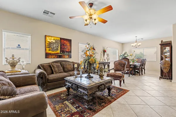 a living room with furniture a rug and a chandelier