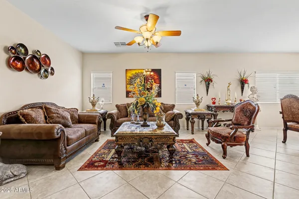 a living room with furniture and a chandelier