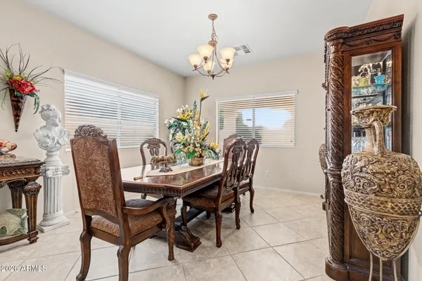 a view of a dining room with furniture and chandelier