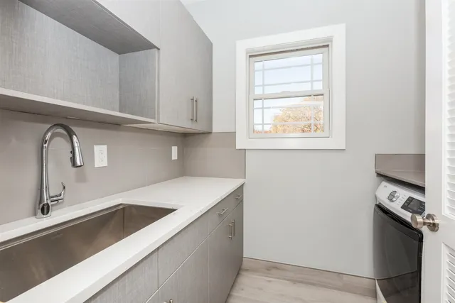 a kitchen with a sink cabinets and a window