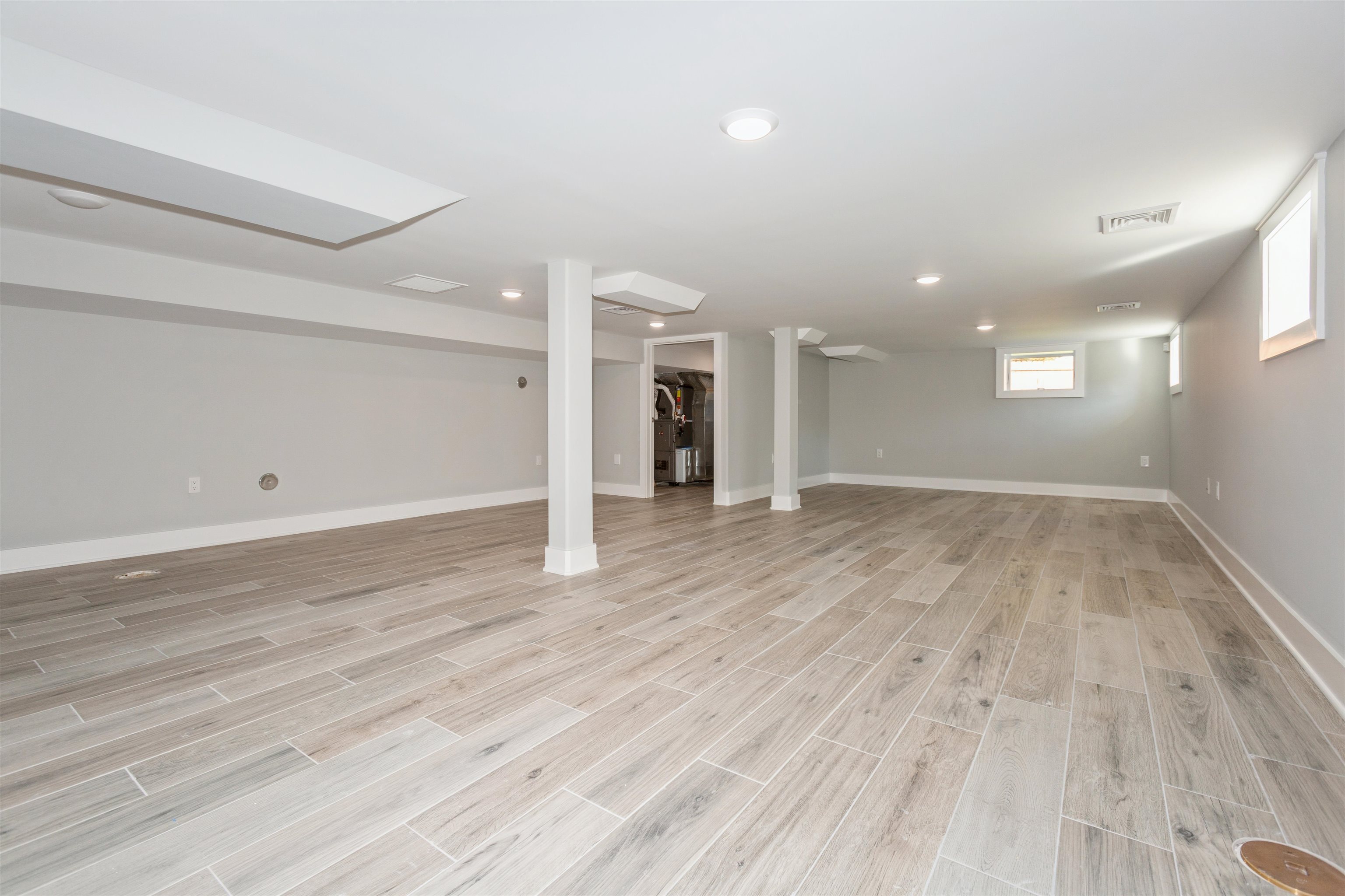 8 Gregory Road Springfield, NJ 07081 - Photo 23 of 30 an empty room with wooden floor and windows