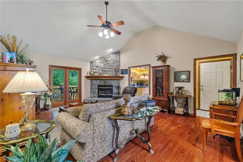 a living room with fireplace furniture and a chandelier