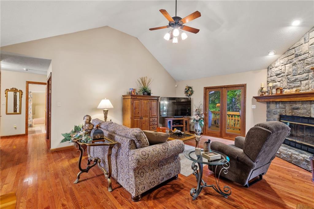 3746 Matthews Road Edinburg, PA 16116 - Photo 15 of 36 a living room with furniture a fireplace and a flat screen tv