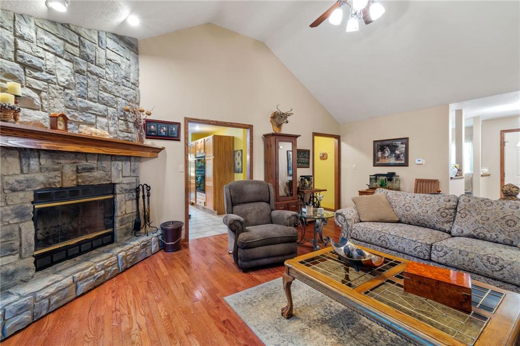 3746 Matthews Road Edinburg, PA 16116 - Photo 17 of 36 a living room with furniture a fireplace and a flat screen tv