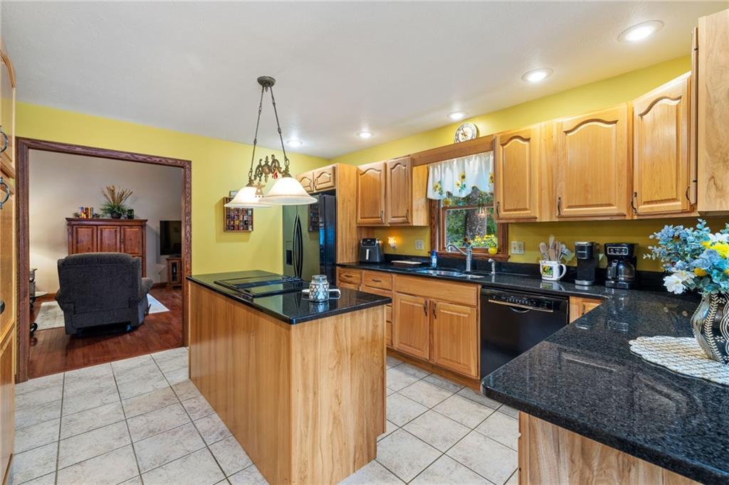 3746 Matthews Road Edinburg, PA 16116 - Photo 20 of 36 a kitchen with granite countertop a stove and white cabinets