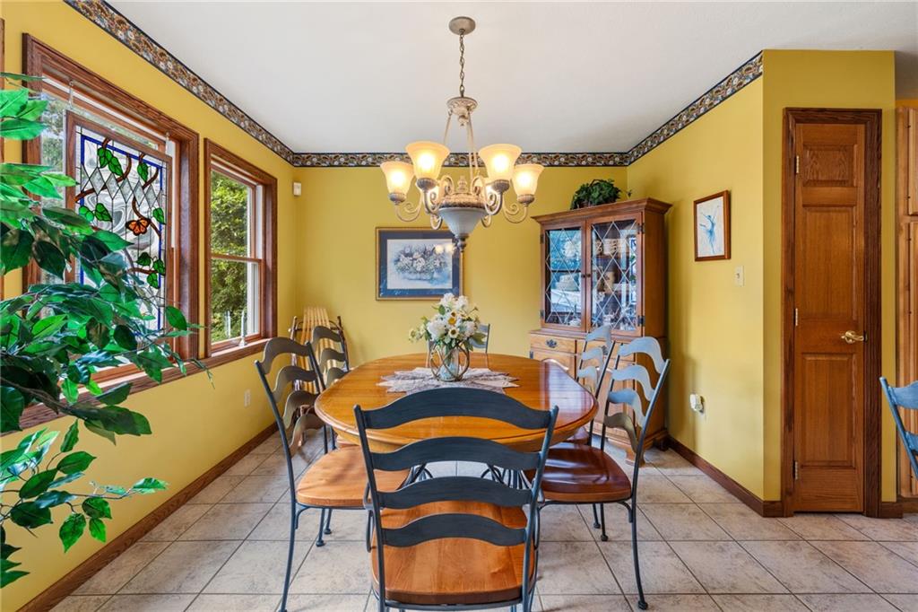 3746 Matthews Road Edinburg, PA 16116 - Photo 22 of 36 a dining room with furniture and chandelier