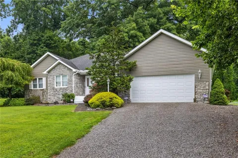 a front view of house with yard and green space