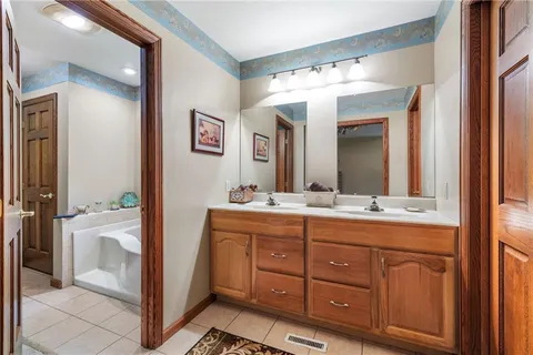 a bathroom with a double vanity sink and a mirror