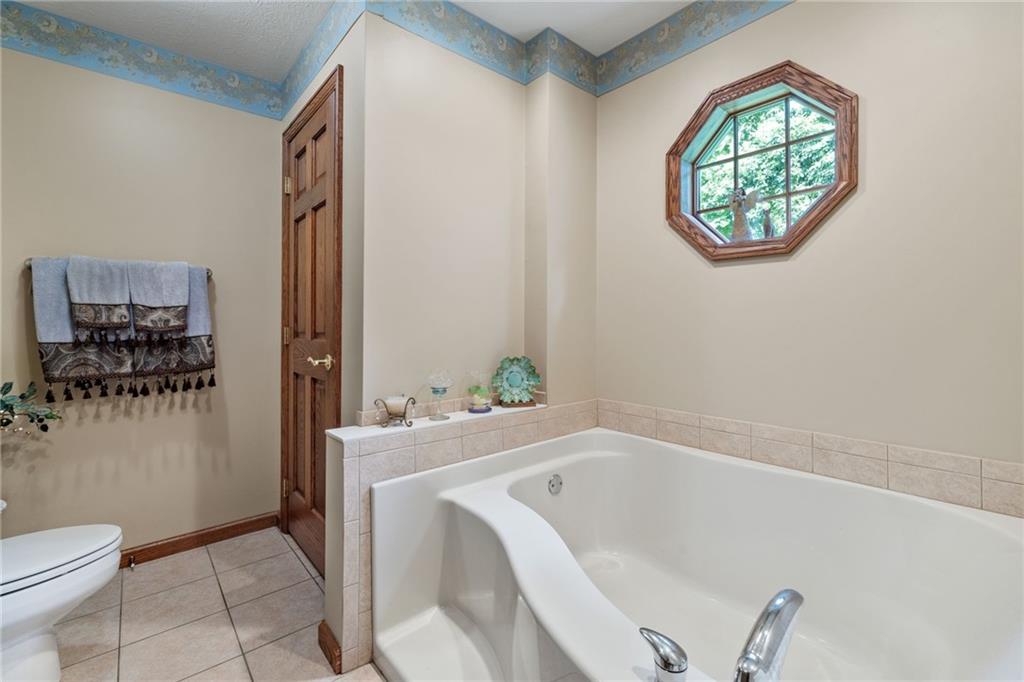 3746 Matthews Road Edinburg, PA 16116 - Photo 33 of 36 a bathroom with a bathtub sink and toilet