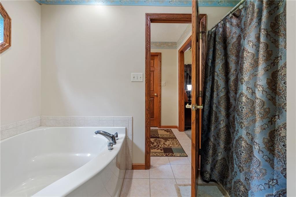 3746 Matthews Road Edinburg, PA 16116 - Photo 34 of 36 a bathroom with bathtub and shower