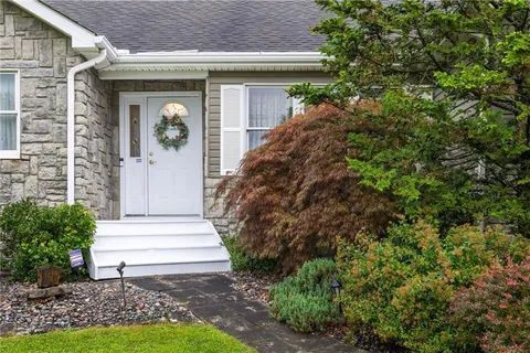 a front view of a house with garden