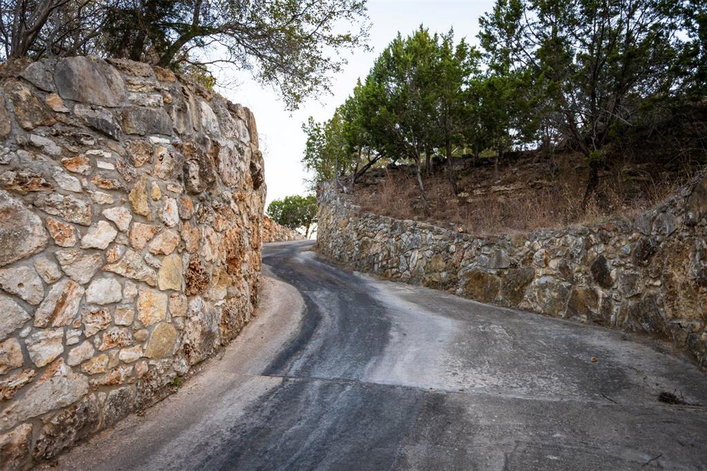 5300 Lookout Ridge Drive Marble Falls, TX 78654 - Photo 30 of 40 Stone wall lined driveway thru canyon to lower yard & Lake access