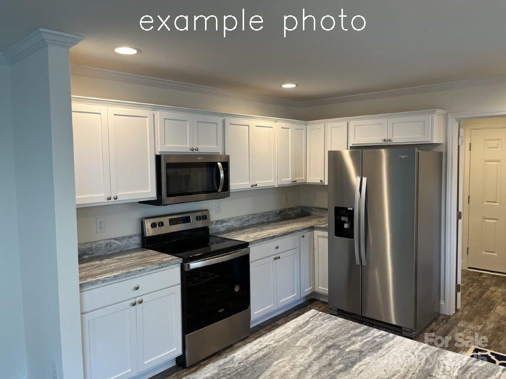106 Lane Street, Unit 6 Morganton, NC 28655 - Photo 6 of 19 a kitchen with stainless steel appliances granite countertop a refrigerator a stove and a sink with wooden floor