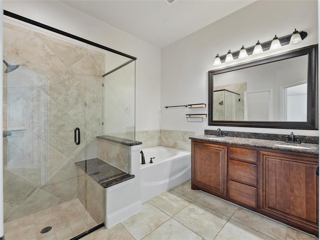 218 Calvert Drive Midlothian, TX 76065 - Photo 12 of 27 a bathroom with a bathtub sink and mirror