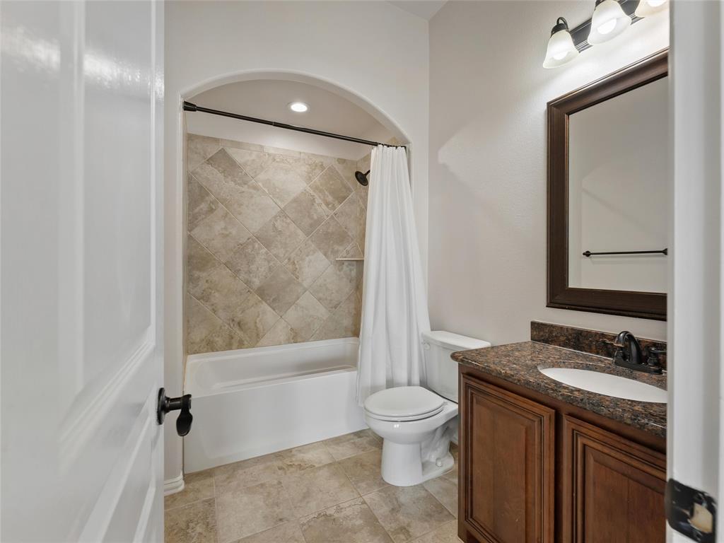 218 Calvert Drive Midlothian, TX 76065 - Photo 16 of 27 a bathroom with a granite countertop sink toilet and shower
