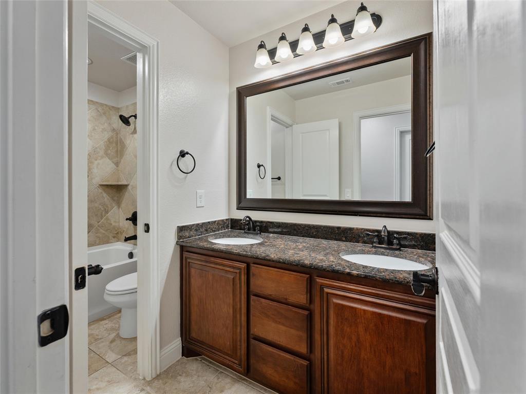 218 Calvert Drive Midlothian, TX 76065 - Photo 18 of 27 a bathroom with a sink vanity and a mirror