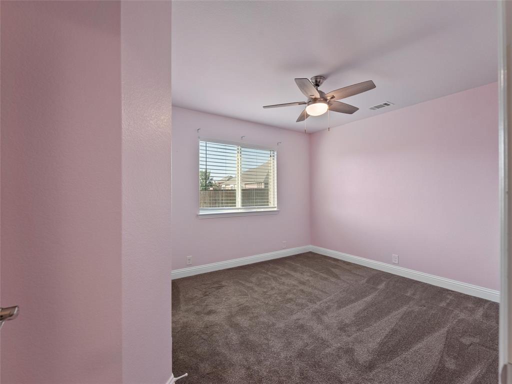 218 Calvert Drive Midlothian, TX 76065 - Photo 19 of 27 an empty room with a chandelier fan and windows