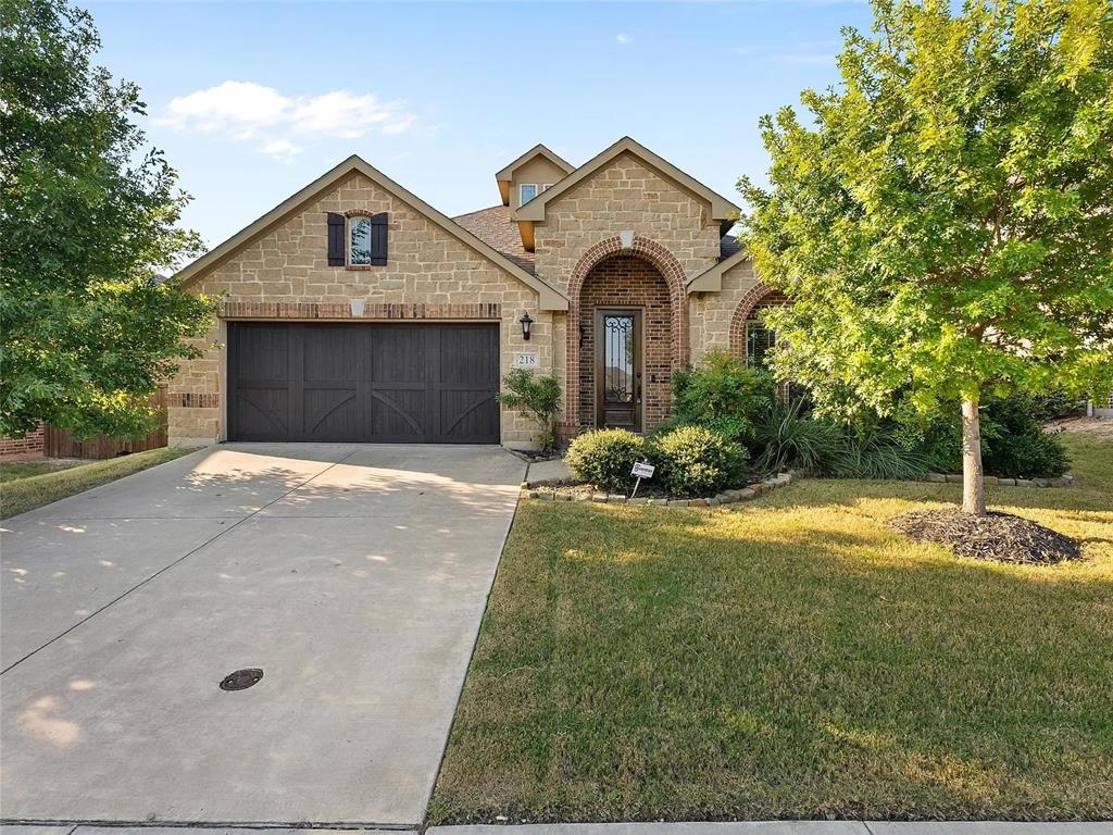 218 Calvert Drive Midlothian, TX 76065 - Photo 2 of 27 a front view of a house with a yard and garage