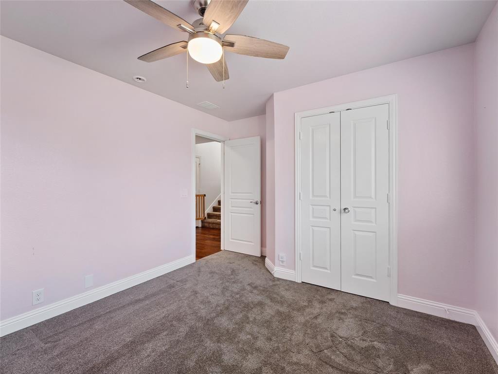 218 Calvert Drive Midlothian, TX 76065 - Photo 20 of 27 an empty room with closet and a ceiling fan