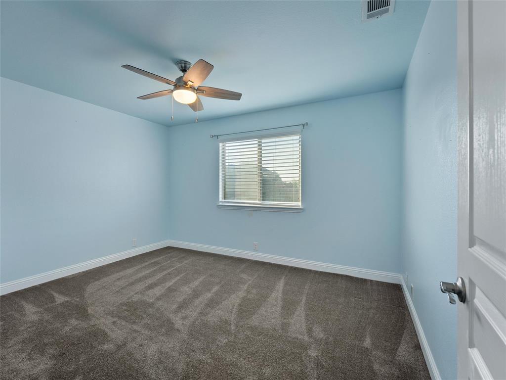 218 Calvert Drive Midlothian, TX 76065 - Photo 21 of 27 an empty room with a window and a fan