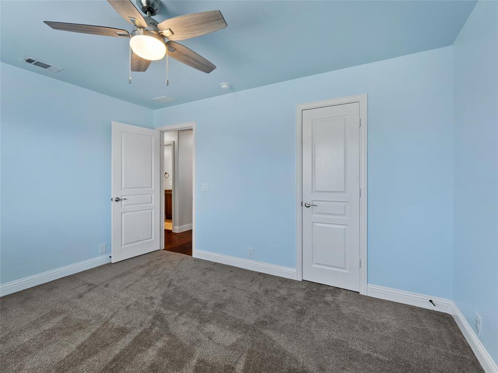 218 Calvert Drive Midlothian, TX 76065 - Photo 22 of 27 an empty room with closet and a ceiling fan