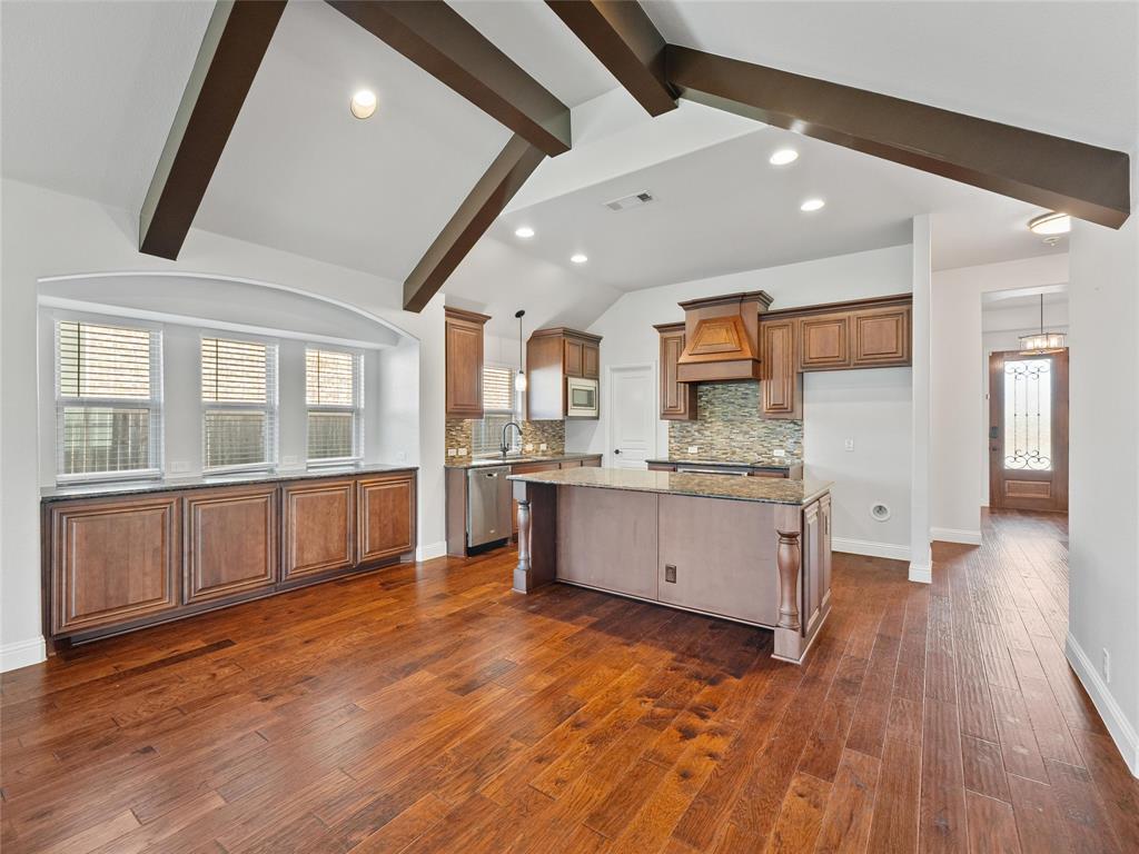 218 Calvert Drive Midlothian, TX 76065 - Photo 5 of 27 a large kitchen with a wooden floor and a large window
