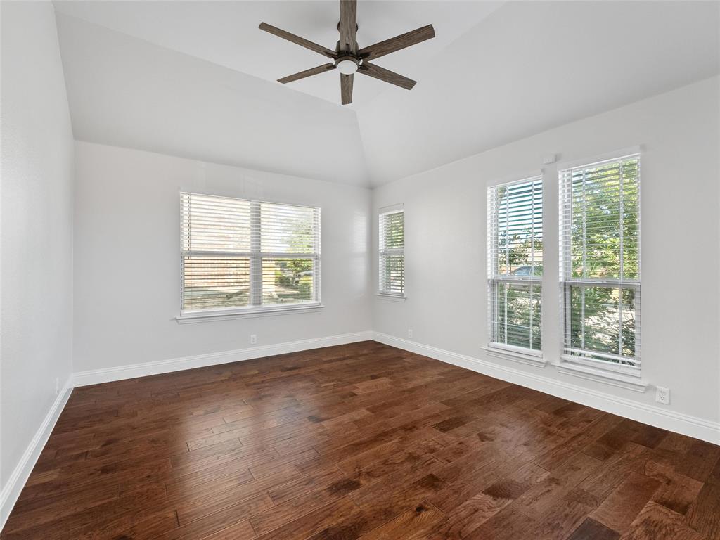 218 Calvert Drive Midlothian, TX 76065 - Photo 8 of 27 a view of an empty room with wooden floor and a window