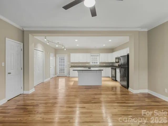 a view of kitchen with kitchen island and stainless steel appliances