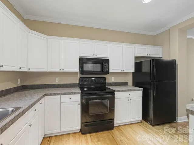 a kitchen with a sink stove and refrigerator