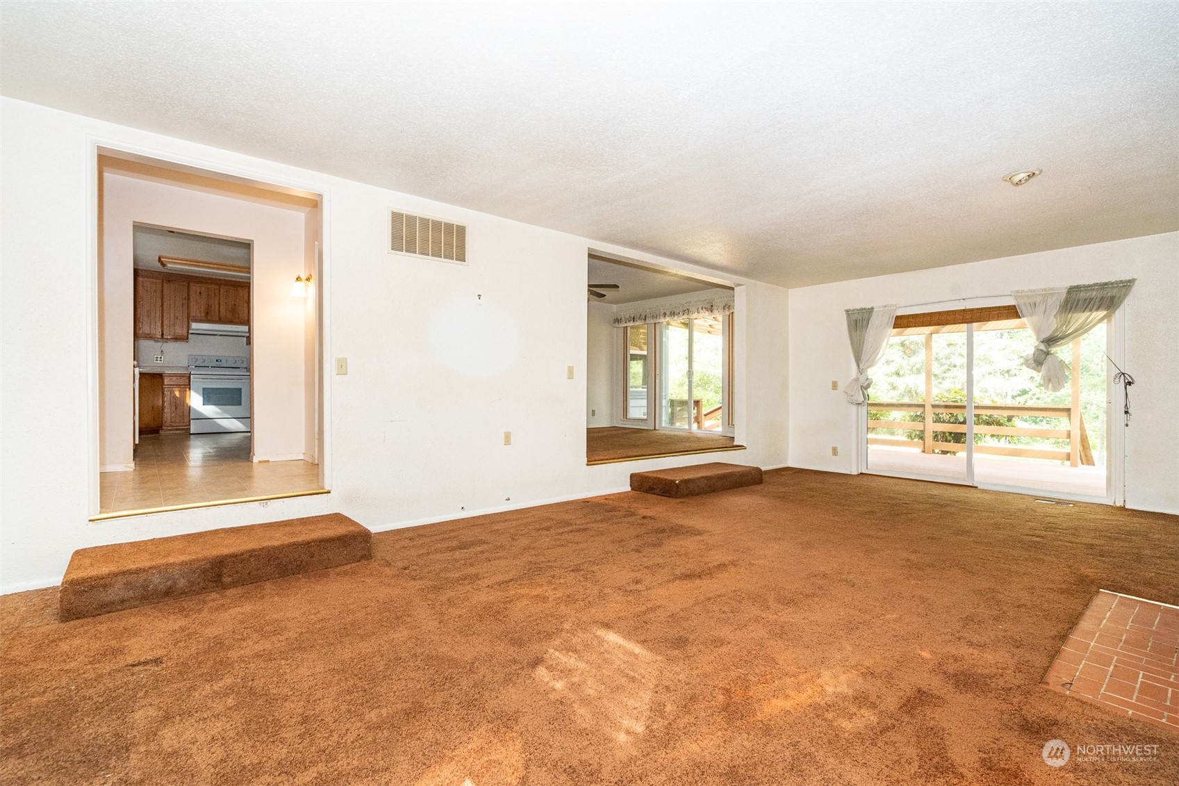 504 Brockway Road Chehalis, WA 98532 - Photo 7 of 40 an empty room with windows and view of wooden floor