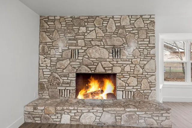 a view of fireplace with wooden floor