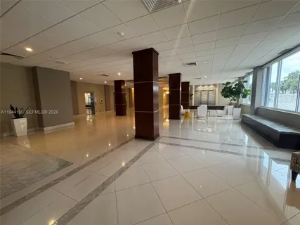 a lobby with furniture and a rug
