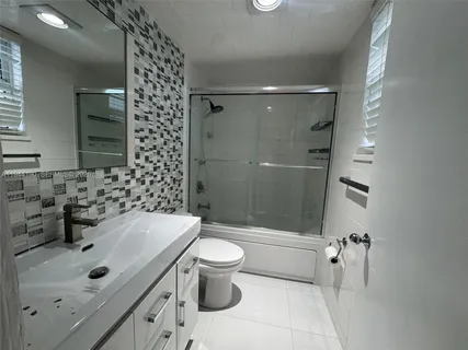 a bedroom with a bed and dresser