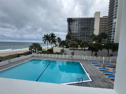 a view of a swimming pool with chairs